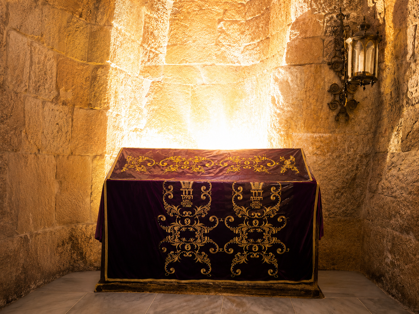 The velvet-draped tziyun of King David lit by warm lamplight on Mount Zion
